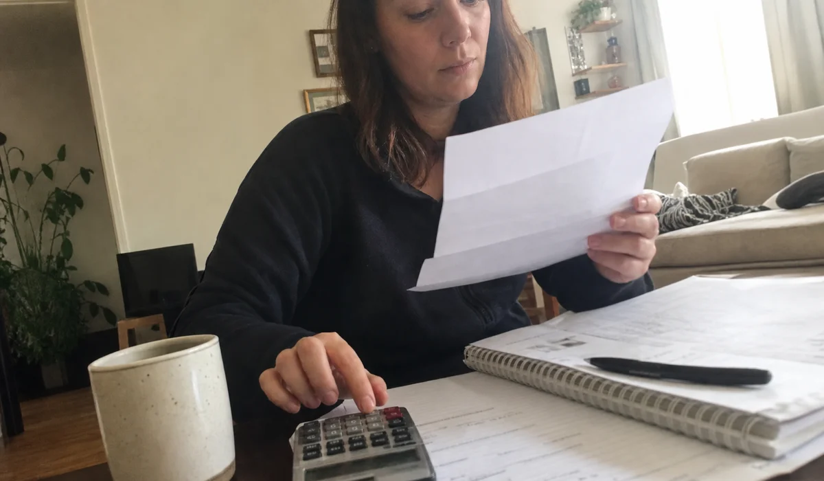 Renter reviewing an apartment approval letter with a risk fee