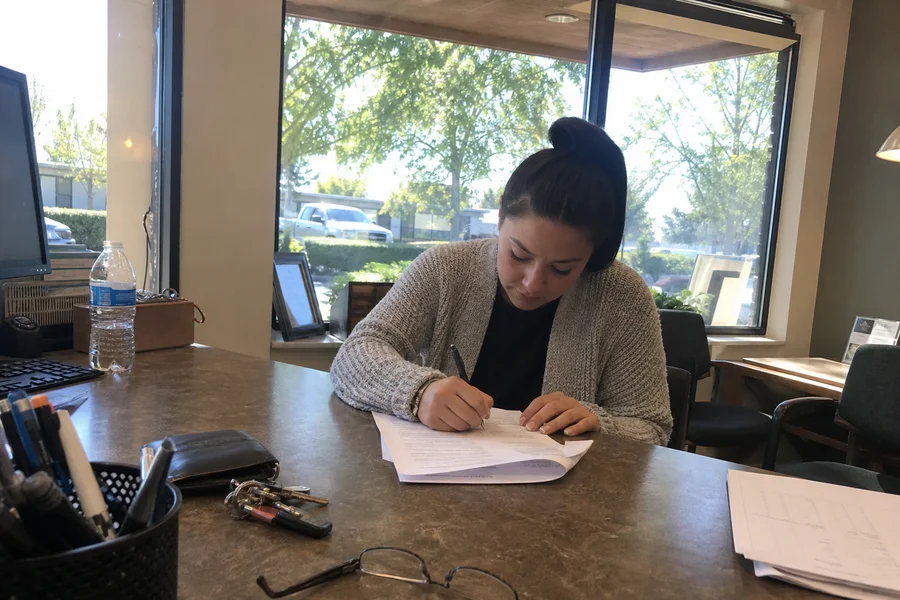 Renter signing a conditional-approval lease