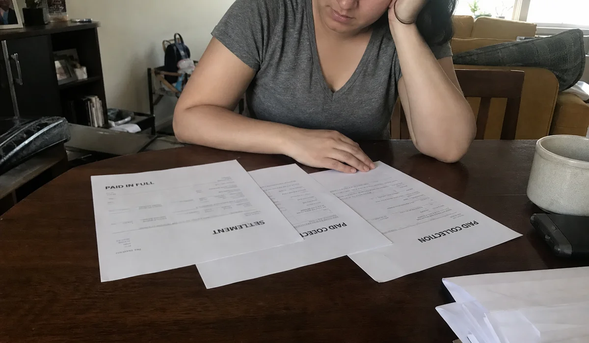 Three documents fanned out showing paid, settled, and paid collection