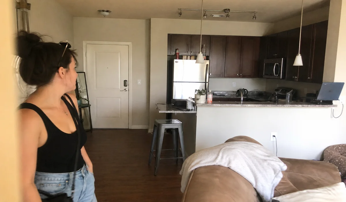 Young renter touring an apartment with a locator